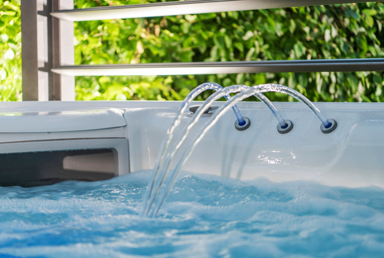 Hot Tub Jacuzzi Fountain and Skimmer Close Up. Modern SPA Inside Residential Garden. Recreation Theme.